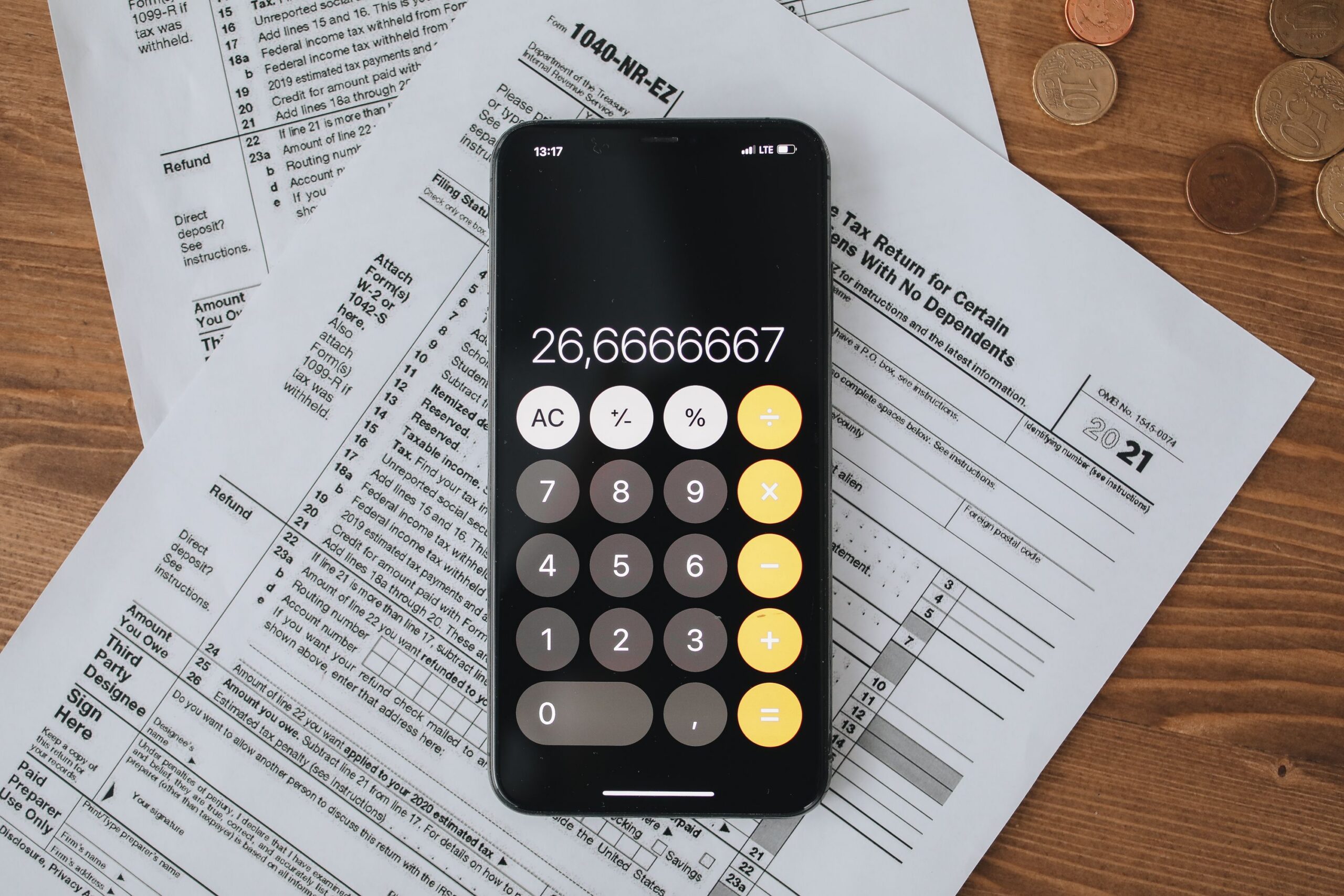 Desk with tax forms, calculator, and paperwork for tax preparation